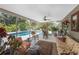 Inviting sun room leading to a refreshing pool and lush landscaping, perfect for relaxation and entertainment at 875 Morrison Ave, Englewood, FL 34223