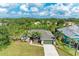 Aerial view of a charming single-story home surrounded by mature trees and lush landscaping at 9211 Koma St, Port Charlotte, FL 33981