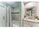Bathroom features shower and tub with neutral tile and updated sink with storage at 9211 Koma St, Port Charlotte, FL 33981