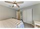 Cozy bedroom showcases modern ceiling fan, closet storage, and light-grey walls at 9211 Koma St, Port Charlotte, FL 33981