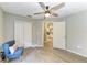 Neutral bedroom features wood-look floors, closet, and ceiling fan at 9211 Koma St, Port Charlotte, FL 33981