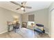 Bright bedroom features wood-look floors, desk, chair, and ceiling fan at 9211 Koma St, Port Charlotte, FL 33981
