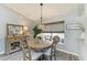 Bright dining area features a round wooden table, charming chandelier, and window that provide lots of light and beauty at 9211 Koma St, Port Charlotte, FL 33981