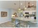 Bright kitchen features granite countertops, a stainless steel appliances, and a breakfast bar for casual dining and entertaining at 9211 Koma St, Port Charlotte, FL 33981