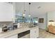 Open-concept kitchen features granite counters, stainless appliances, and a view into the living area, perfect for entertaining guests at 9211 Koma St, Port Charlotte, FL 33981