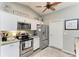 This modern kitchen includes stainless steel appliances, granite countertops, and ample white cabinetry to maximize space and style at 9211 Koma St, Port Charlotte, FL 33981