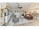 Cozy living room with stylish furnishings, a ceiling fan, and access to the backyard at 9211 Koma St, Port Charlotte, FL 33981