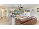Inviting living room features a ceiling fan, coastal decor, and neutral paint, creating a comfortable and stylish living space at 9211 Koma St, Port Charlotte, FL 33981