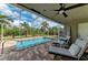 Screened-in pool with brick patio and outdoor seating at 9211 Koma St, Port Charlotte, FL 33981