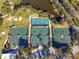 Aerial view of well-maintained tennis courts showing multiple green and red playing surfaces surrounded by trees at 1 Curacao Cir # 44, Englewood, FL 34223