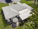 Aerial view of the backyard showcasing a patio with an umbrella and well-maintained landscaping at 1 Curacao Cir # 44, Englewood, FL 34223