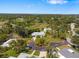 Aerial view of the home nestled among lush greenery and mature trees in a peaceful neighborhood at 1 Curacao Cir # 44, Englewood, FL 34223