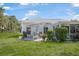 Backyard featuring a patio with an outdoor dining set and a well-maintained lawn at 1 Curacao Cir # 44, Englewood, FL 34223