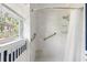 Modern walk-in shower with marble-style tiles and grab bars at 1 Curacao Cir # 44, Englewood, FL 34223
