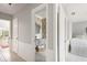 Hallway view showcasing a well-decorated bathroom with wainscotting and stylish fixtures at 1 Curacao Cir # 44, Englewood, FL 34223