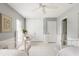 Spacious bedroom with gray walls, white trim, tile flooring, and ceiling fan at 1 Curacao Cir # 44, Englewood, FL 34223