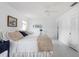 Airy bedroom featuring a plush bed, fan, and an entrance to an ensuite at 1 Curacao Cir # 44, Englewood, FL 34223