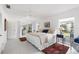 Bright bedroom with a king bed, and sliding glass doors to the exterior at 1 Curacao Cir # 44, Englewood, FL 34223