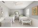 Bright bedroom with gray walls, white trim, tile flooring, and ceiling fan at 1 Curacao Cir # 44, Englewood, FL 34223