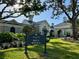 Beautiful exterior view of The Club at Boca Royale's entrance, sign, and surrounding lush landscaping at 1 Curacao Cir # 44, Englewood, FL 34223