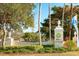 Boca Royale Golf & Country Club entrance with lush landscaping and decorative signage at 1 Curacao Cir # 44, Englewood, FL 34223
