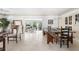 Spacious dining area with large table, built-in cabinets, and seamless flow into the living room at 1 Curacao Cir # 44, Englewood, FL 34223