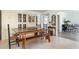 Charming dining room with a long table and bench seating, and an elegant china cabinet at 1 Curacao Cir # 44, Englewood, FL 34223
