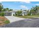 Beautiful single-story home with a paved driveway and lush landscaping at 1 Curacao Cir # 44, Englewood, FL 34223