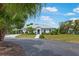 Stunning single-story home with palm trees, a paved driveway, and a well-kept lawn at 1 Curacao Cir # 44, Englewood, FL 34223