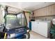 Attached garage featuring a golf cart, washer, and dryer with storage space at 1 Curacao Cir # 44, Englewood, FL 34223