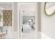 Hallway view into a powder room and bedroom with matching decor at 1 Curacao Cir # 44, Englewood, FL 34223