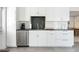 Modern kitchen with stainless steel appliances, stylish backsplash, and ample counter space for cooking and entertaining at 1 Curacao Cir # 44, Englewood, FL 34223