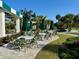 Charming outdoor dining area with comfortable seating and scenic views of the meticulously kept golf course at 1 Curacao Cir # 44, Englewood, FL 34223