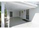 Covered outdoor patio with neutral tones, offering a shaded entryway to the house at 1 Curacao Cir # 44, Englewood, FL 34223