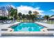 Community pool with a diving board and an adjacent shaded lounge area at 1 Curacao Cir # 44, Englewood, FL 34223
