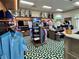 Well-stocked pro shop with golf apparel, bags, and accessories displayed on shelves and racks with bright lighting at 1 Curacao Cir # 44, Englewood, FL 34223