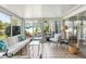 Light-filled sunroom with tile flooring, comfortable seating, and access to a patio at 1 Curacao Cir # 44, Englewood, FL 34223