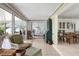 Bright sunroom with wicker furniture, tiled floors, and a seamless connection to the outdoors at 1 Curacao Cir # 44, Englewood, FL 34223