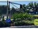 Tennis court behind a black chain-link fence with a sign reading, 