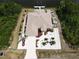Aerial view of a waterfront home featuring lush landscaping, a private dock, and a boat lift along the canal at 10064 Cocoa Beach St, Port Charlotte, FL 33981
