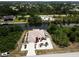 Aerial view of a waterfront home featuring lush landscaping, a private dock, and a boat lift along the canal at 10064 Cocoa Beach St, Port Charlotte, FL 33981