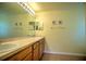 Bathroom features a large vanity with dual sinks, a large mirror, and ample counter space at 10064 Cocoa Beach St, Port Charlotte, FL 33981
