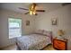 Bedroom featuring a ceiling fan, neutral walls, tile flooring, and a window at 10064 Cocoa Beach St, Port Charlotte, FL 33981