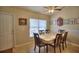 Dining area featuring a ceiling fan, tan walls, tile flooring, and a table for six at 10064 Cocoa Beach St, Port Charlotte, FL 33981