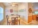 Dining room features a ceiling fan, tan walls, tile flooring, and a table for six at 10064 Cocoa Beach St, Port Charlotte, FL 33981