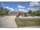 Charming single-Gathering home featuring a two-car garage, well-maintained landscaping, and an American flag at 10064 Cocoa Beach St, Port Charlotte, FL 33981