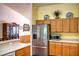 Bright kitchen featuring stainless refrigerator and ample cabinet space at 10064 Cocoa Beach St, Port Charlotte, FL 33981