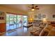 Inviting living room with sliding glass doors to screened lanai and lake view at 10064 Cocoa Beach St, Port Charlotte, FL 33981