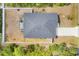 Aerial top shot of the home displaying the roof and enclosed patio at 129 David Blvd, Rotonda West, FL 33947