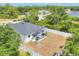 An aerial view highlighting the home's location, complete with a screened porch and fenced backyard at 129 David Blvd, Rotonda West, FL 33947